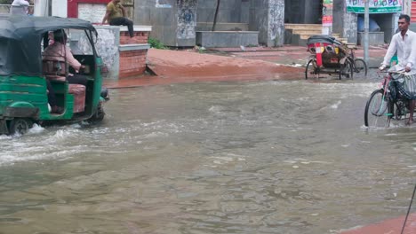 transportation passing flooded road during flood crisis due to heavy rainfall in south asia