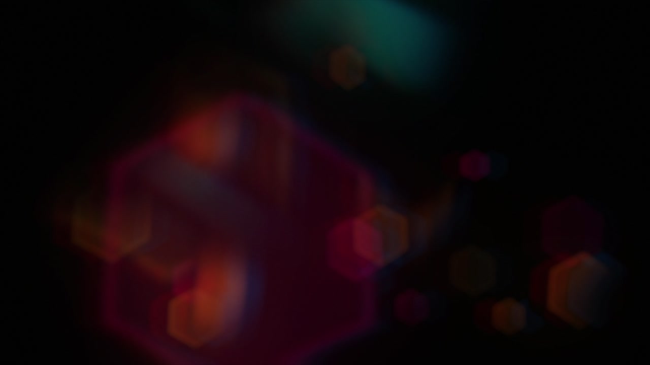 Abstrakte heksagonale bokeh-effekter og lyslækager på sort baggrund