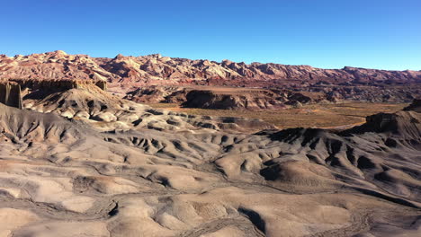 aerial view of badlands during a beautiful clear blue sky, tracking shot