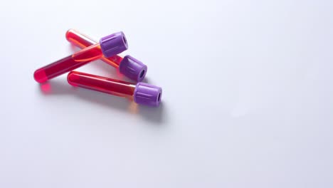 close up of blood samples on white background with copy space, slow motion