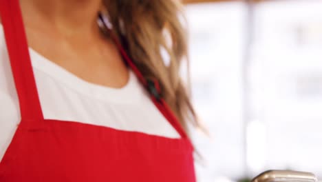 waitress typing a text message at counter