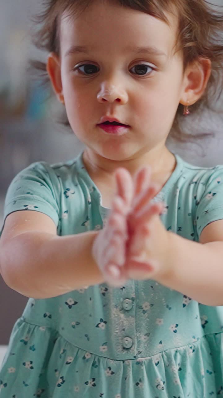 A Young Child Curiously Examines Her Hand with Soft Substance, Capturing Pure Wonder and Playful Exploration in a Cozy Indoor Setting