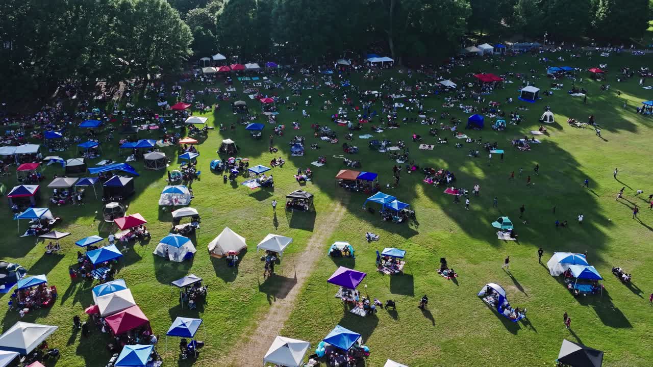 Tents And People Crowding On Meadows Of Piedmont Park During Jazz Festival Outdoor Concert In Atlanta, Georgia, USA. Aerial Shot