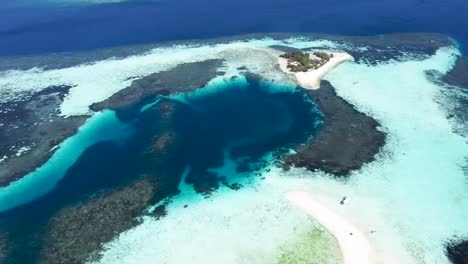 overview of paluau katangan sandbank coral reef in east komodo island indonesia, aerial pan left reveal shot