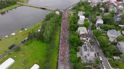 crowd of people gathering at the start line of an urban marathon in iceland