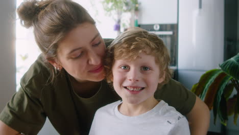 portrait of happy mother with little son at home