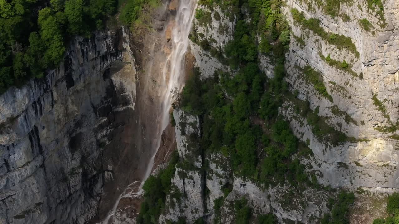 Aerial view of the Seerenbach Falls cascading down steep limestone cliffs near Amden and Betlis, overlooking Walensee in Switzerland, one of the tallest waterfalls in the country
