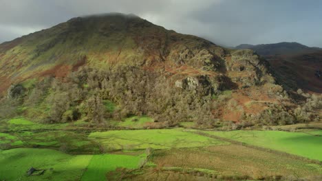 Aerial:-mountains-in-Snowdonia-Wales,-countryside-landscape-in-sun-and-clouds