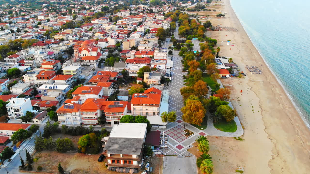 Panorama of the Asprovalta with multiple buildings and greenery. Aegean sea coast. Sunny day. Greece