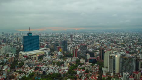 vista aérea en movimiento de lapso de tiempo de nubes nubladas que se mueven sobre la ciudad, revelando un cielo colorido del amanecer, en méxico, américa - reversa, hiperlapso, disparo de drones