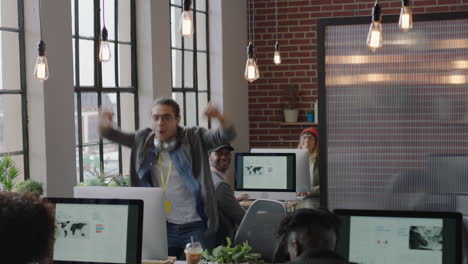 happy caucasian business man celebrating success enjoying victory jumping excited colleagues clapping arms raised showing support cheerful enthusiastic teamwork in diverse office