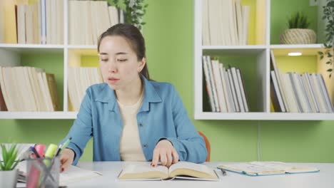 asian young female student doing research.