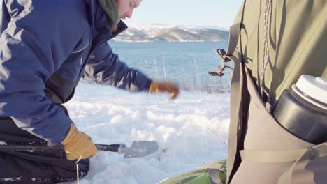 Camper-Removing-And-Cutting-Twigs-Of-Plant-With-Mini-Shovel