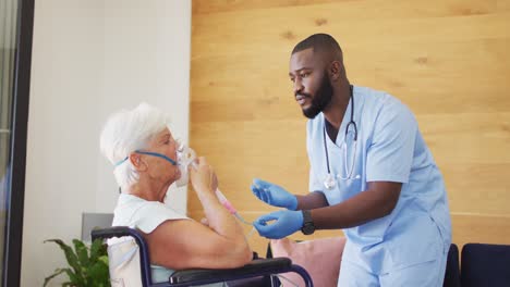 video of african american male doctor keeping oxygen to caucasian senior woman