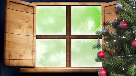 christmas tree and wooden window frame against snowflakes falling on green background