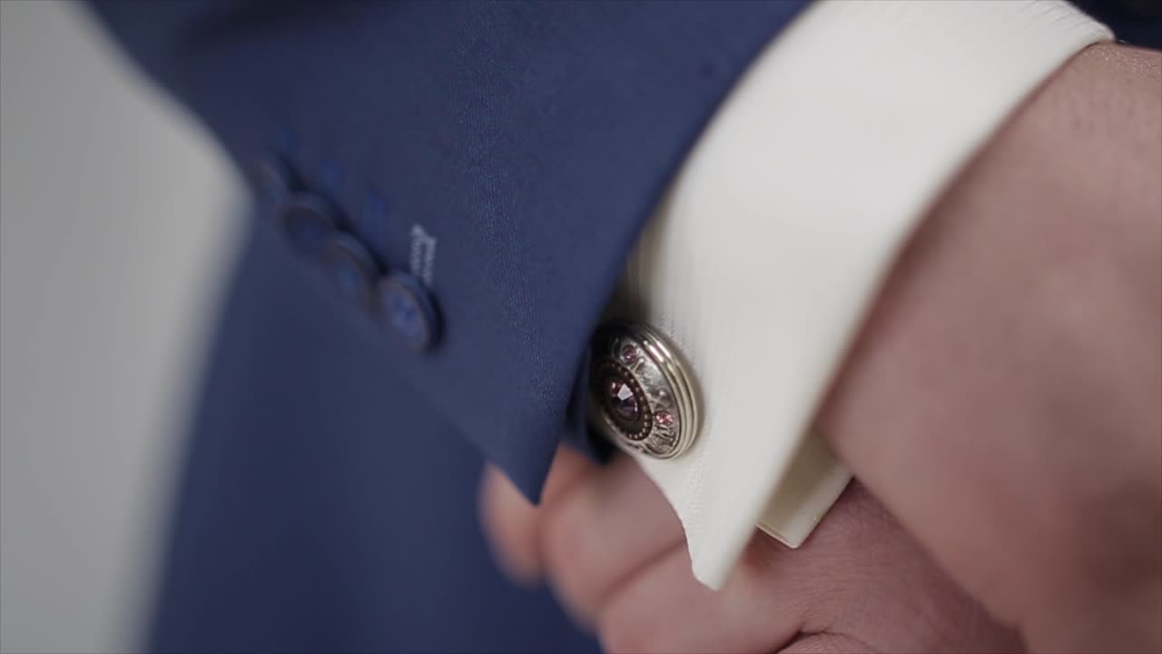 Tuxedo and white shirt sleeve buttons close up