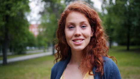 young woman smiling in park