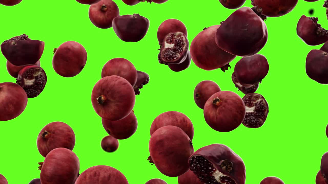 Falling pomegranate on a green background