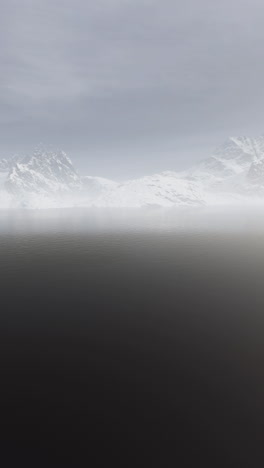 misty mountains reflecting in a still lake