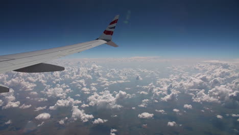 view with clouds over the ocean from airplane window