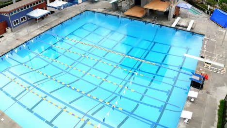 aerial view of an empty outdoor swimming and diving pool complex