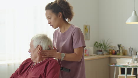physical therapist working with elderly man