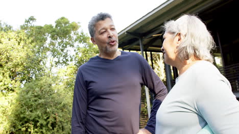 Happy-diverse-senior-couple-talking-in-garden