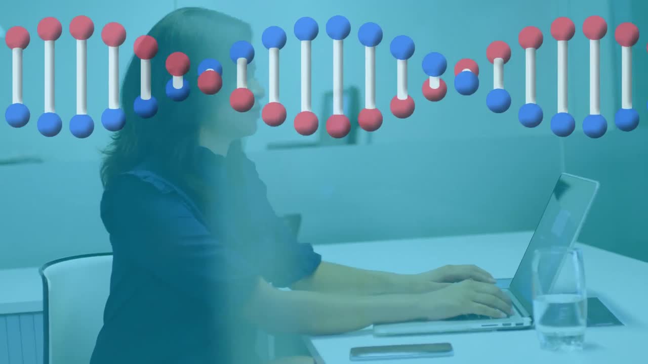 Animation of dna strand spinning over businesswoman using laptop