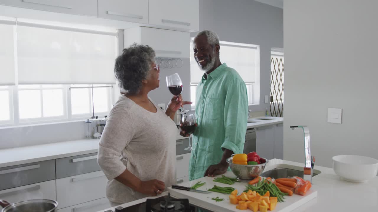 A senior African american couple enjoying a glass of wine in social distancing