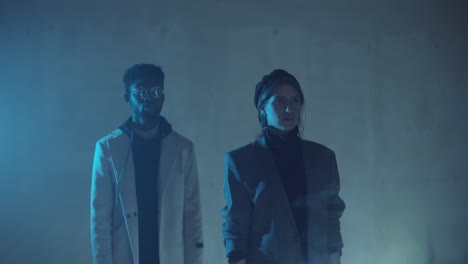 Couple-Standing-in-Dark-Studio-with-Moving-Flat-Sheet-of-Laser-Light