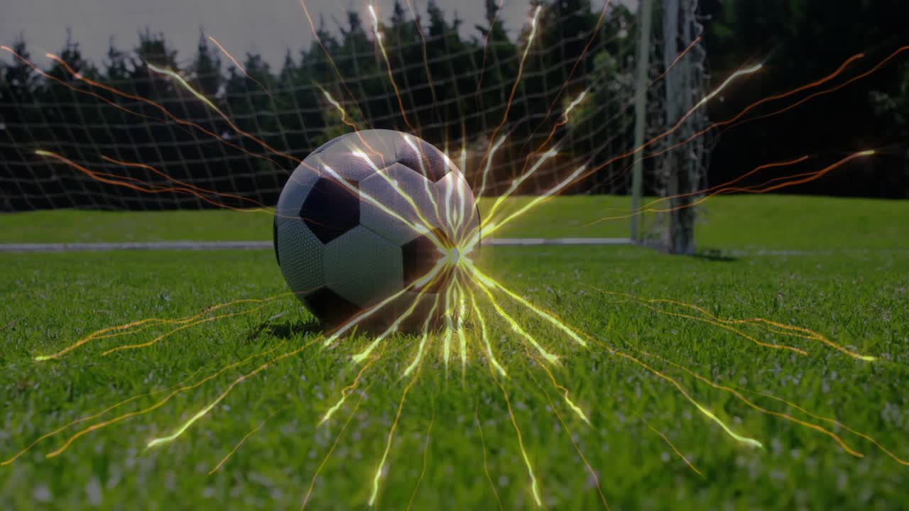 Attacker coming, kicking soccer ball, causing keeper diving to stop goal, ball pulsing tech energy