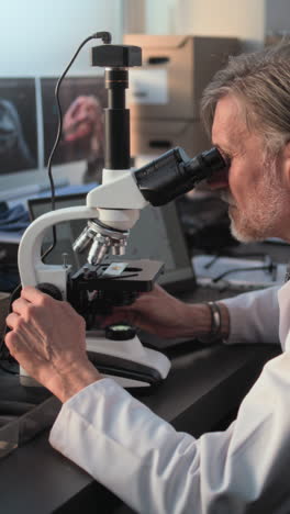 scientist using microscope in lab