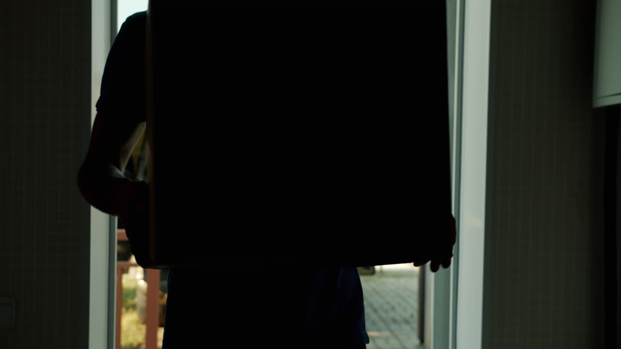 Man Carrying Cardboard Boxes