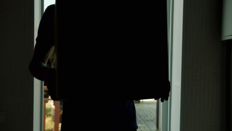 man carrying cardboard boxes