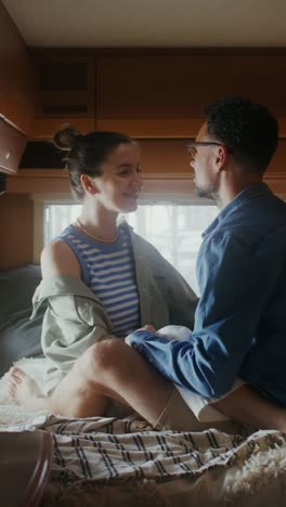 couple kissing in a camper van