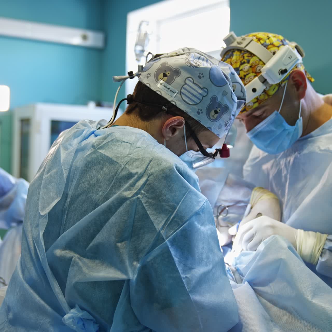 Surgery specialists perform the operation on thyroid. Cooperating professionals in funny caps working hard at surgery. Nurse at backdrop in blur