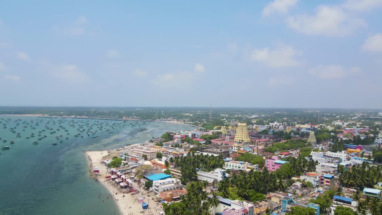Ripresa aerea con drone che mostra l'iconico tempio di Rameshwaram circondato dalla vivace città.