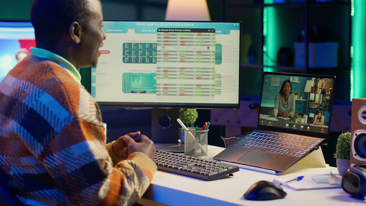 Man attending online meeting while analyzing stock market data on computer