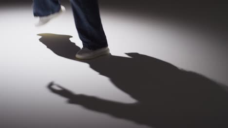 close up studio shot showing feet of woman dancing with low key lighting against grey background 6