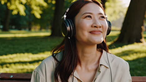 woman listening to music with headphones in a park