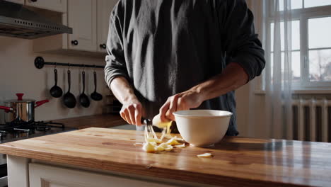 man chopping potatoes in the kitchen