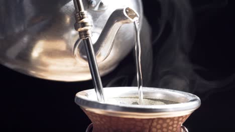 pouring water to make argentine green tea