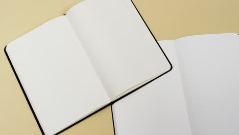 video of books with white blank pages and copy space on yellow background