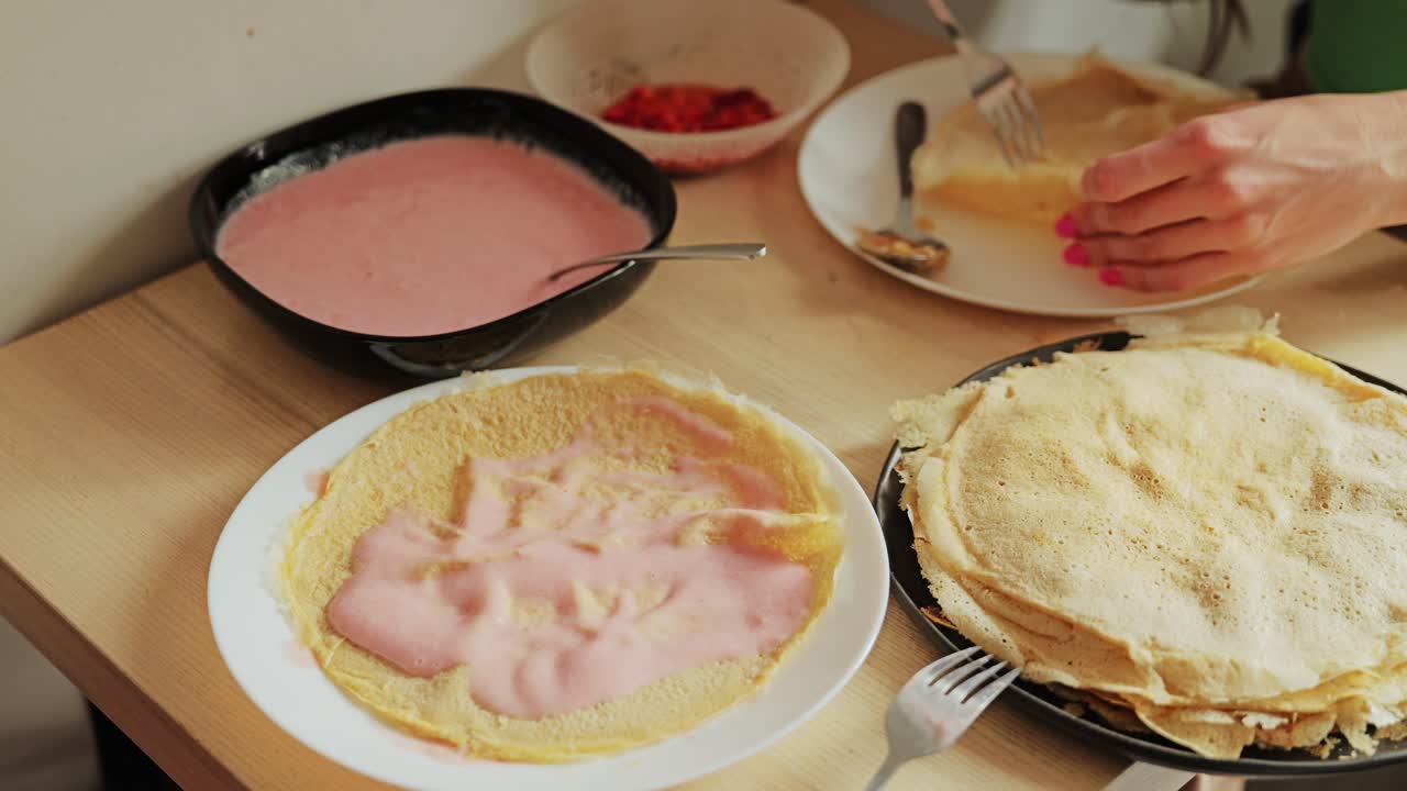 A couple shares quiet morning joy while making sweet strawberry crepes together