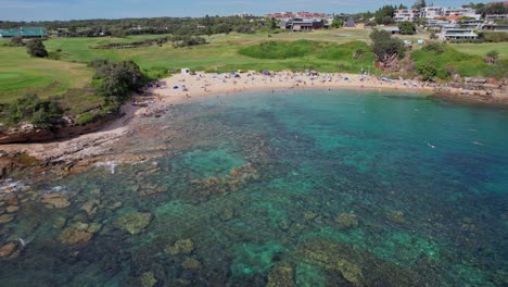 Scenic-Little-Bay-Beach-With-Tourists-In-Sydney,-New-South-Wales,-Australia---Aerial-Drone-Shot