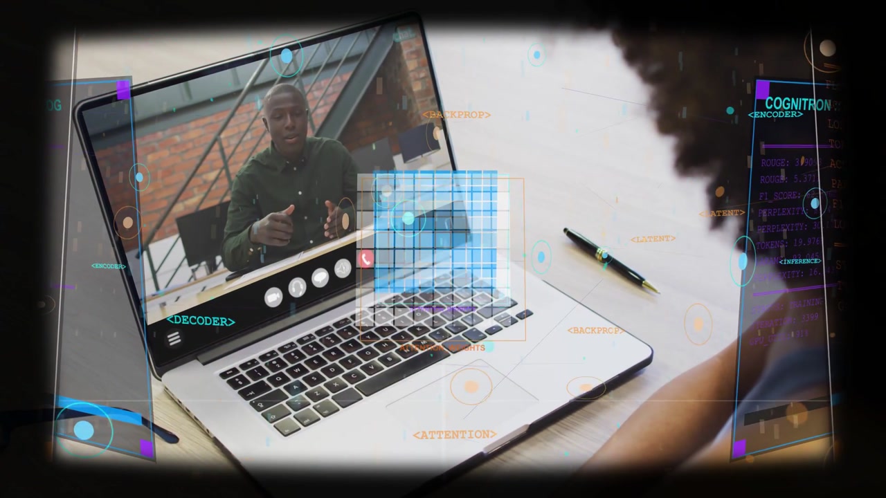 Presenter speaking in dark shirt desk occupant watching laptop at desk to follow data with overlays