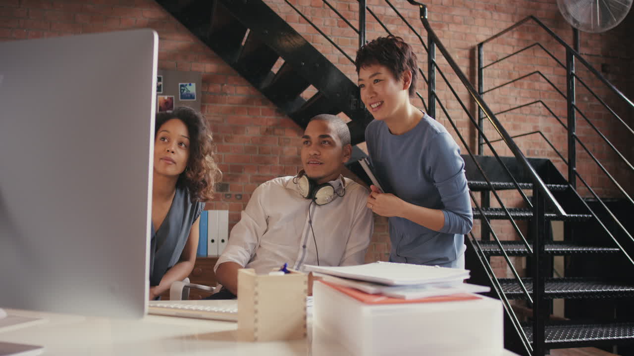 Asian software engineer offering advice to male designer businessman