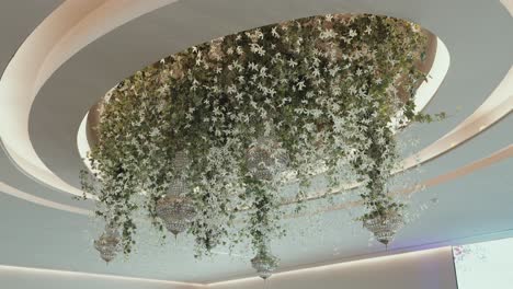 lush floral ceiling with cascading greenery and crystal chandeliers
