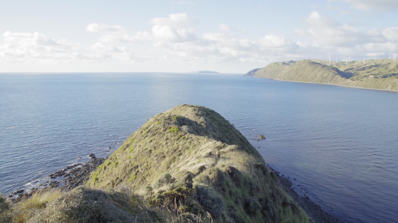 바다로 이어지는 곶을 따라 능선 길을 내려다보는 정적 샷