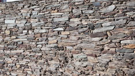 aged layered stone detail from historic castle wall in monsaraz portugal